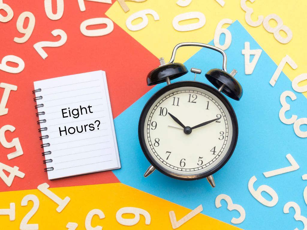 Picture of clock and notebook saying "Eight Hours?"