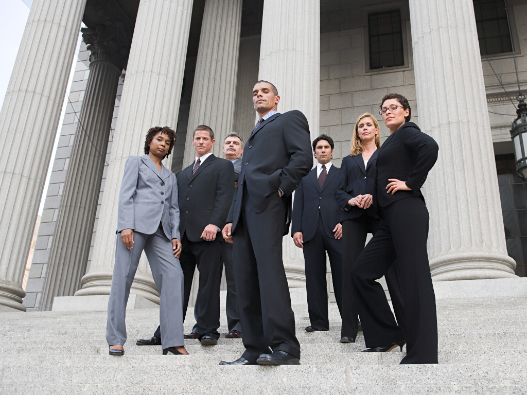 Group of lawyers in suits on the steps of a government building