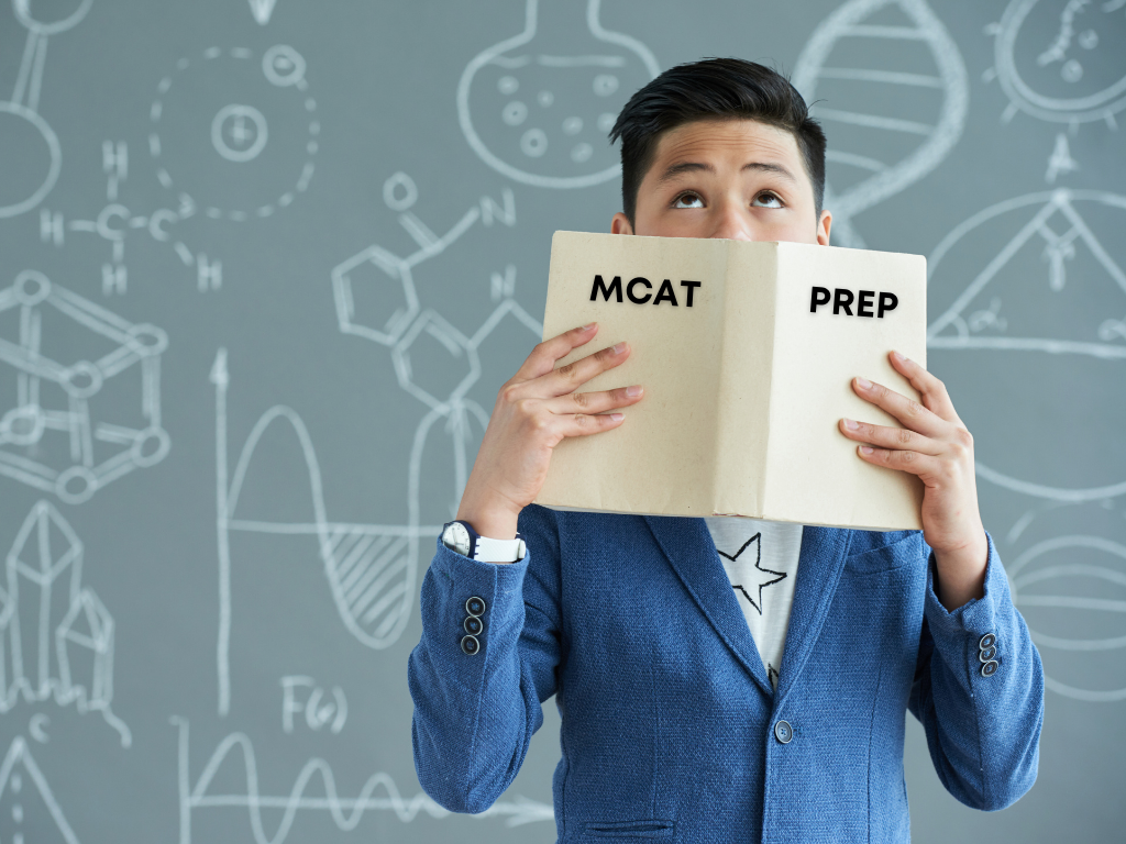 Man holding MCAT study book; MCAT study plan
